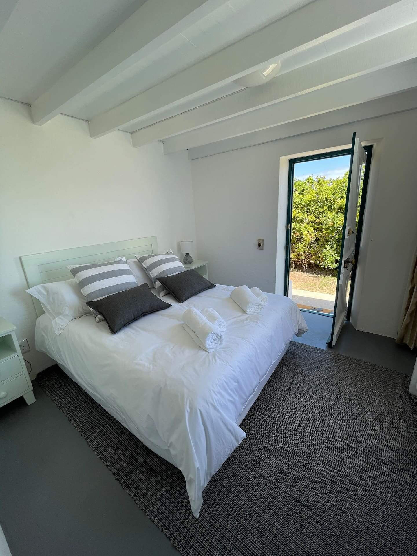 Oceanbreeze Cottage with its own door standing open onto the garden